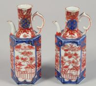 A PAIR OF JAPANESE IMARI PORCELAIN HEXAGONAL JUGS painted with panels of native flora, each base