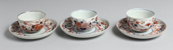 A SET OF THREE JAPANESE IMARI PORCELAIN CUPS AND SAUCERS, each with floral decoration. Plates 14.5cm