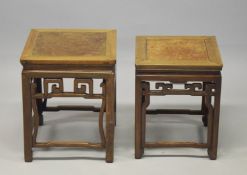 TWO GOOD CHINESE HARDWOOD SQUARE STANDS, each inset with a burr wood panel, above a carved frieze
