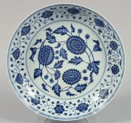 A LARGE CHINESE BLUE AND WHITE PORCELAIN DISH painted with numerous flower heads and scrolling vine.