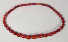 AN AMBER STYLE BEADED NECKLACE, with graduated beads.