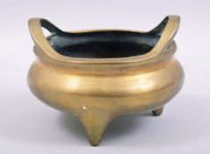A GOOD CHINESE BRASS TWIN HANDLE TRIPOD CENSER, the base with mark, 14cm diameter.