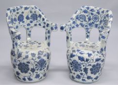 A PAIR OF CHINESE BLUE AND WHITE POTTERY GARDEN CHAIRS. 2ft 1ins high.
