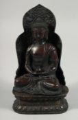 A BRONZE FIGURE OF SEATED BUDDHA, rested on a detachable base. 22cm high overall.