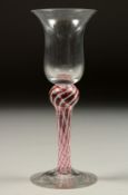 A GEORGIAN WINE GLASS with inverted bell bowl and column stem. 6.25ins high.