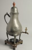 A PEWTER PEAR SHAPED COFFEE POT AND STAND. 18ins high.