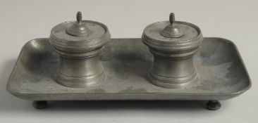 AN 18TH CENTURY LONDON PEWTER TWO BOTTLE INKSTAND. 9ins long.