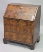 AN 18TH CENTURY WALNUT FALL FRONT BUREAU with a fitted interior, three small drawers above two