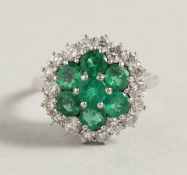 A GOOD EMERALD AND DIAMOND CLUSTER RING the centre with seven emeralds surrounded by eighteen