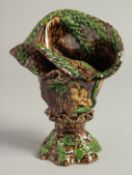 A SMALL MAJOLICA BROWN GLAZE VASE. 6ins high.