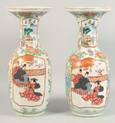 A PAIR OF IMARI VASES with flowers and panels of figures.