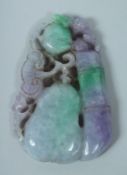 A LARGE CARVED TWO TONE JADE PENDANT 10cm long.