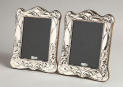 A PAIR OF SILVER ART DECO STYLE PHOTOGRAPH FRAMES 7.5ins x 6ins.