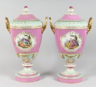 A SUPERB LARGE PAIR OF BERLIN TWO HANDLED URNS AND COVERS painted with reverse panels of figures,