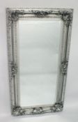 A LARGE DECORATIVE SILVER FRAMED MIRROR. 6ft x 3ft 2ins.