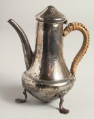 A SMALL COFFEE POT with wick handle on three pad feet. London 1903.