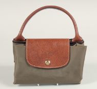 A LONGCHAMP FOLDING TOTE BAG. 8ins x.5ins with two handles.