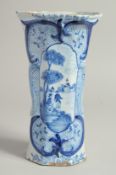 A DUTCH BLUE AND WHITE TIN GLAZE VASE with figures in a landscape. 9ins high.