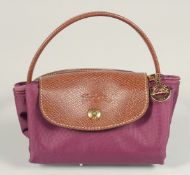 A LONGCHAMP FOLDING TOTE BAG. 7ins x 3.5 with two handles.