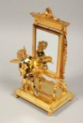 A GOOD GILT BRONZE CUPID with a mirror. 9ins high.