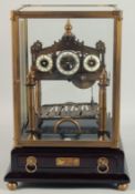 A GOOD SKELETON ROLLING BALL CLOCK with three dials. 11ins in a glass case.