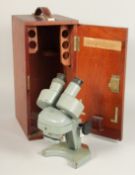 A DOUBLE GREY PAINTED MICROSCOPE, W. WATSON & SONS LTD., stamped WATSON, BARNET. No. 141133, 9ins