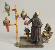 A VIENNA PAINTED BRONZE PARROT SELLER with parrots, owl, and monkey by his side. 6ins high.