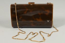 A FAUX TORTOISESHELL EVENING PURSE with long gilt chain. 7ins long.