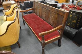 A 19TH CENTURY OAK PANEL BACK SETTLE. 71ins long x 41ins high x 26ins deep.