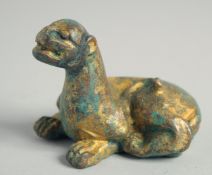 A CHINESE GILDED METAL SEATED LION. 6.5cm high.