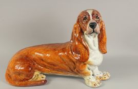 A LARGE CONTINENTAL POTTERY BASSET HOUND. 26ins long.
