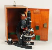 A COOKE TROUGHTON & SIMMS MICROSCOPE. No. M 703227. 11 ins high in a mahogany case.