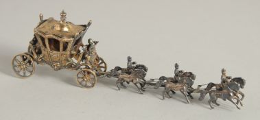 A CONTINENTAL SILVER GILT CORONATION COACH AND HORSES. 7ins long