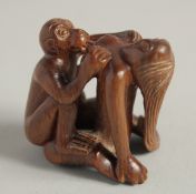 A CARVED WOOD EROTIC NETSUKE. 1.5ins.