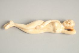 A CARVED BONE DOCTOR'S NUDE FIGURE. 5ins long.
