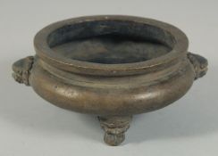 A CHINESE BRONZE CIRCULAR CENSER with dog of Foe handles. 5ins diameter.