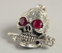 A SILVER SKULL PENDANT.