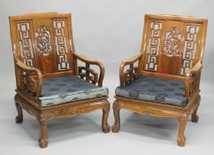 A PAIR OF CHINESE CARVED REDWOOD ARMCHAIRS.