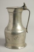 A LARGE 18TH CENTURY PEWTER JUG AND COVER. 10ins high.