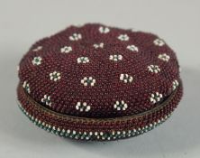 A SMALL CIRCULAR BEAD WORK BOX AND COVER. 2.5ins diameter.