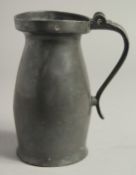 AN 18TH CENTURY PEWTER JUG 7ins high.
