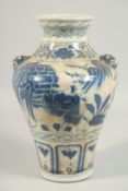 A CHINESE BLUE AND WHITE PORCELAIN VASE decorated with figures with dog of Foe handles. 13ins high.