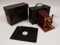 AN EARLY KODAK CAMERA, RED BELLOWS, in a leather case.