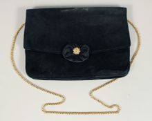 A BLACK VELVET EVENING BAG 6.5ins x 9.5ins with gilt stud.