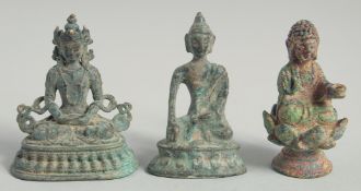 THREE SMALL INDIAN BRONZE BUDDHAS. 6cm high