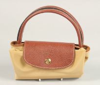 A LONGCHAMP FOLDING TOTE BAG. 7ins x 3.5 with two handles.