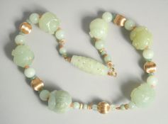 A SUPERB CHINESE JADE AND GOLD NECKLACE set with six long carved jade stones in set with small