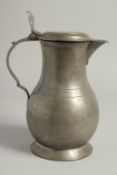A GOOD 18TH CENTURY PEWTER FLAGON-JUG. 9ins high.