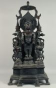 A LARGE CHINESE BRONZE DEITY on a shrine with two attachments. 3ft 4ins high.