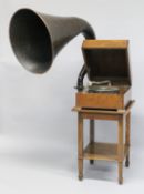 AN E.M.G. OAK CASED ELECTRICALLY OPERATED GRAMOPHONE, with original horn and table, circa. 1930,